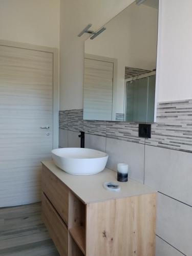 a bathroom with a white sink and a mirror at L' Aurora Marina in SantʼAnna Arresi