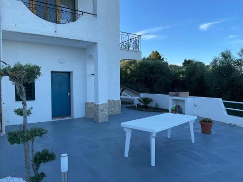 a patio with a white table in front of a building at Casa Zora - Vista Mare in Vieste