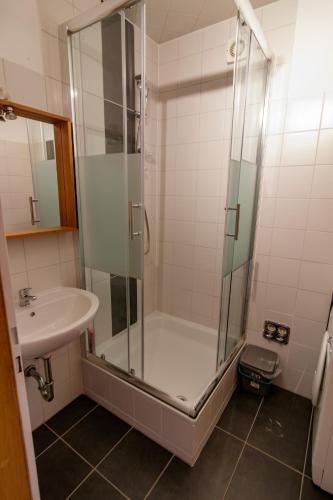 a bathroom with a shower and a sink at B10 Rooms in Baden-Baden