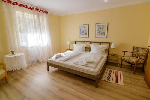 a bedroom with a bed with white sheets and a window at B10 Rooms in Baden-Baden