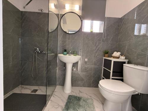 a bathroom with a shower and a toilet and a sink at Beachfront Luxury Studio with Panoramic Sea View in Ialysos