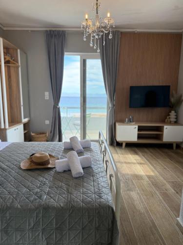 a bedroom with a bed with a view of the ocean at Beachfront Luxury Studio with Panoramic Sea View in Ialysos