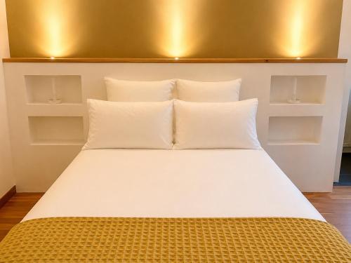 a bed with white pillows in a room at Souvenir D Italie in Alatri