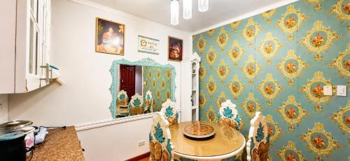 a dining room with blue and gold wallpaper at Condotels at Albergo Hotel Baguio in Baguio