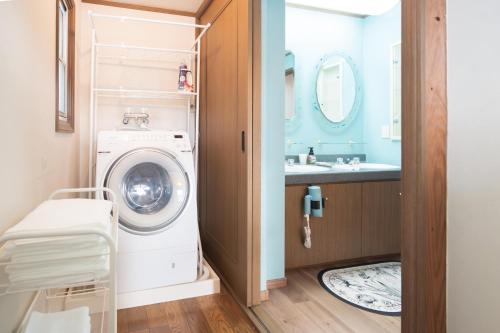 a bathroom with a washing machine and a sink at umiakari in Naruto