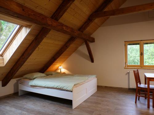 a bedroom with a bed in the attic at Škola Kačerov in Zdobnice