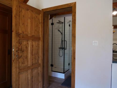 a bathroom with a shower and a glass door at Škola Kačerov in Zdobnice