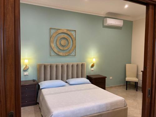 a bedroom with a bed and a desk and a chair at Vignali Residence in Diso