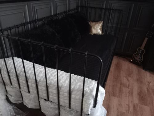 a black bed with white sheets and pillows at SUITE THE BLESSING "Where Heaven Touches Earth" in Bruges