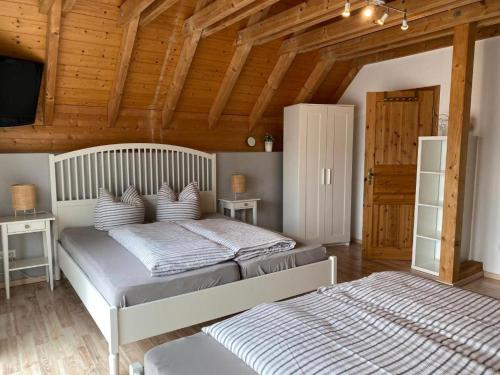 a bedroom with two beds in a room with wooden ceilings at Gästehaus Brigitte Duri in Rust