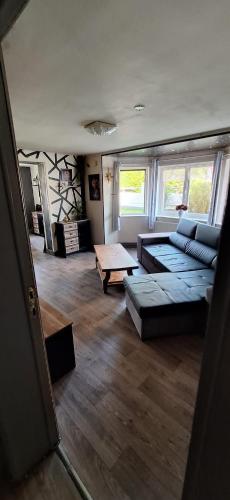 a living room with a couch and a coffee table at Le White Garden in De Panne