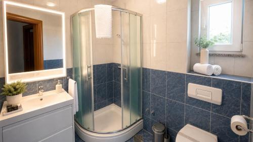 a bathroom with a shower and a sink at Apartments Stina & Villa Ina in Seget Vranjica