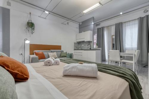 a bedroom with a large bed with two pillows on it at Flow Urban Living by DiffeRent in Ferrara