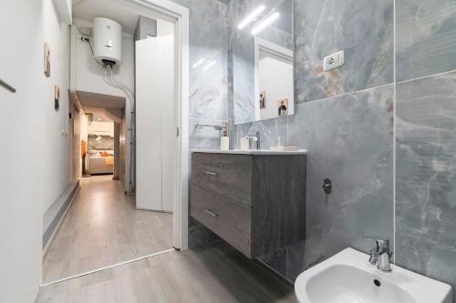 a bathroom with a sink and a mirror at Flow Urban Living by DiffeRent in Ferrara