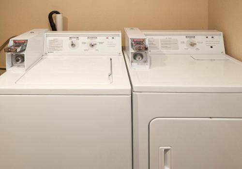 two white washers and a refrigerator in a room at Days Inn by Wyndham Duluth Lakewalk in Duluth
