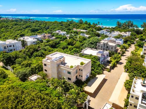 an aerial view of a building with the ocean in the background at Sandbox Apartment 4 Diani Beach Kenya in Ukunda