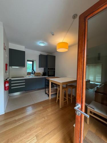 a kitchen with a table and a dining room at Tapada De Sao Domingos in Gondomar