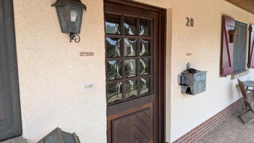a wooden door on a building with a window at Ferienwohnung Ella in Föckelberg