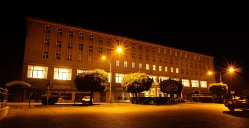 a large building at night with a street light at Hotel ZRUČ in Zruč nad Sázavou