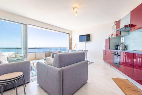 a living room with a couch and chairs and a kitchen at Magnifique appartement avec vue mer panoramique ! in Valras-Plage
