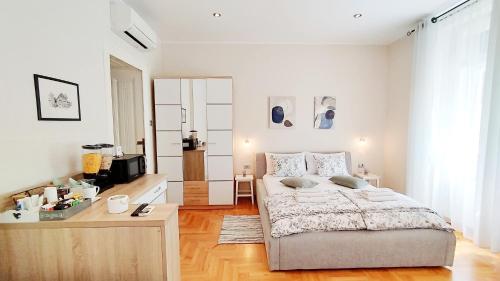 a bedroom with a bed and a television in it at Lavender - City Room with free parking in Pula