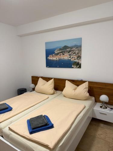 two beds in a room with a view of the ocean at Villa Bavaria in Starigrad