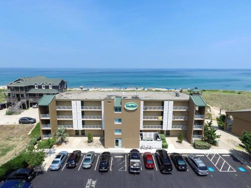 an aerial view of a hotel with cars parked in a parking lot at Shutters on the Banks in Kill Devil Hills