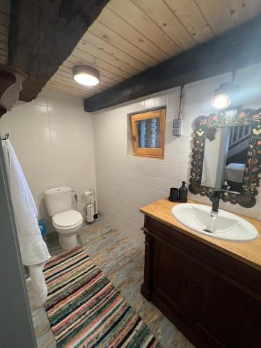 a bathroom with a sink and a toilet and a tv at Archita 155 in Archita