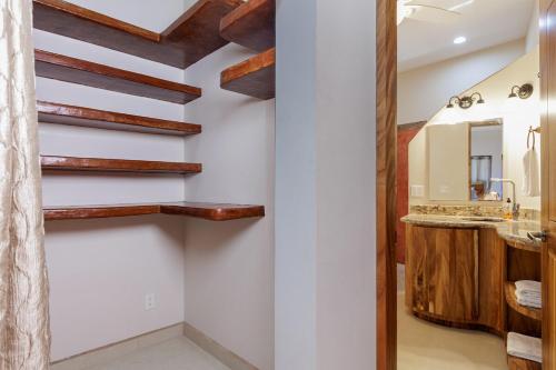 a bathroom with white walls and wooden beams at Casa Girasol Ocean Views Steps to Beach in Buenavista