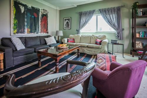 a living room with a couch and a table at Beit Al Baraka in Um Qeis