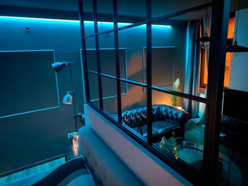 a room with a couch in front of a mirror at Boutique 11 Postavarului by Kronstay in Braşov