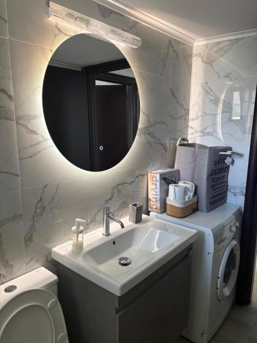 a bathroom with a sink and a mirror at Moiras apartments in Lefkada
