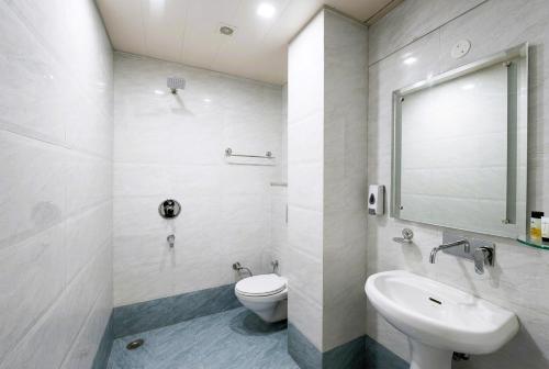a bathroom with a toilet and a sink at Hotel SP Grand Near Mohali Bus Stand & Civil Hospital in Mohali