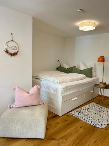 a bedroom with a bed and a chair in it at Wohlfühlen & Entdecken in der barocken Altstadt in Blieskastel
