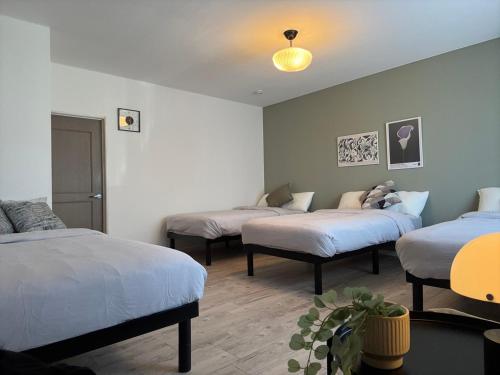 a room with three beds in a room at Private Rock Onsen Villa Orin & Zen Garden in Shiraoi