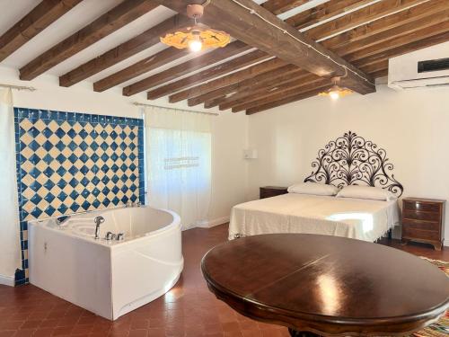 a room with a bath tub and a bed at Relais Casa Spanu in Dorgali