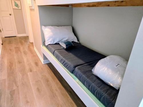 a bed in a room with two pillows on it at Beachfront Condo 103 in North Topsail Beach