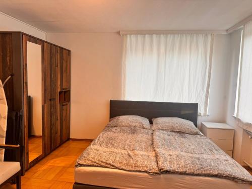 a bedroom with a bed with a blanket on it at E&H Appartements in Bregenz