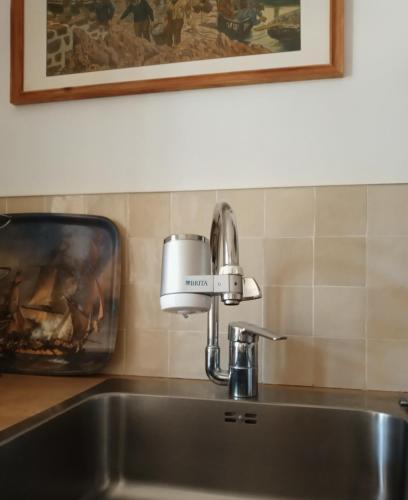a kitchen sink with a mixer on top of it at Maison de vacances Ty Kornog in Pont-Aven