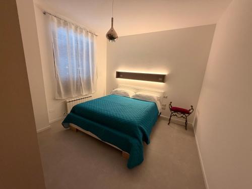 a small bedroom with a green bed and a window at Da Nella 1 in Ancona