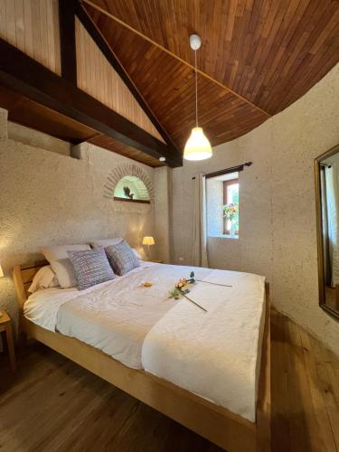 a bedroom with a large bed with a wooden ceiling at Lacoume Saint Jacques in Auch