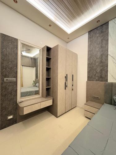 a bathroom with a large mirror and a sink at Jhigu in Siliguri