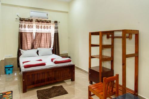 a bedroom with a bunk bed and a ladder at Shridevi Residency in Honāvar