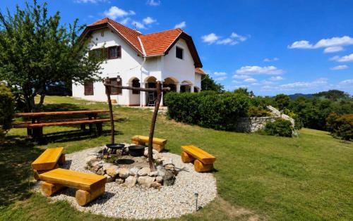 a fire pit in a yard in front of a house at Dorono House in Balatonudvari