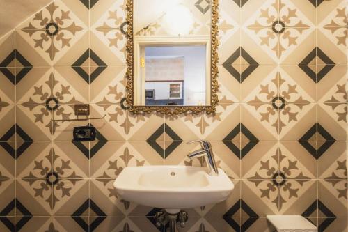 a bathroom with a sink and a mirror at 3BR Townhouse with Private Rooftop in Bormla in Taʼ Penza