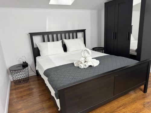 a baby sitting on top of a bed at Dare apartments 3 in Giurgiu