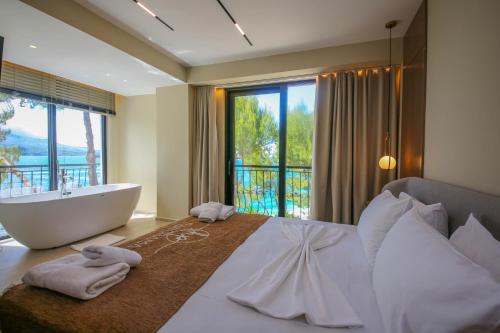 a bedroom with a large bed with a tub and a window at Hotel Panorama Ksamil in Ksamil