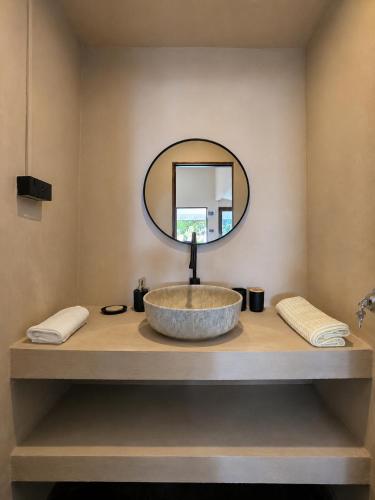 a bathroom with a sink and a mirror on a counter at Flow Jungle Residency in Haad Yao