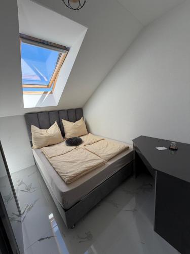 a bedroom with a bed with a cat laying on it at SC Apartments Bad Goisern - contactless check in in Bad Goisern