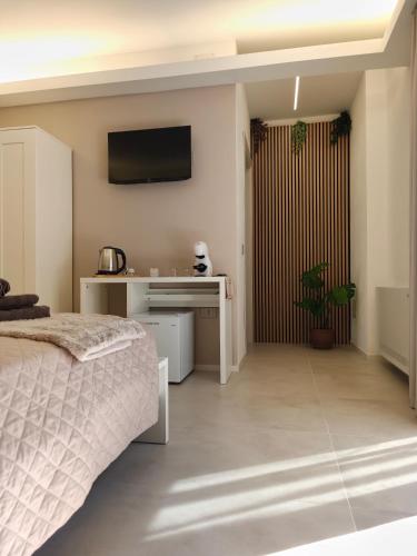 a bedroom with a bed and a desk and a television at Sole Relax Pula in Pula